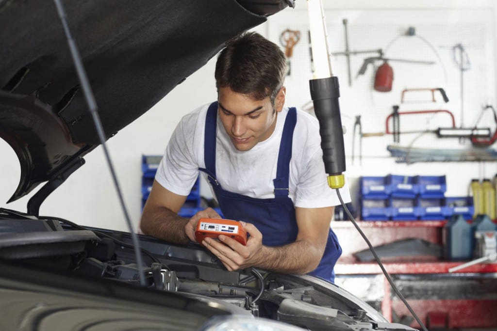 Mechanic working under the hood